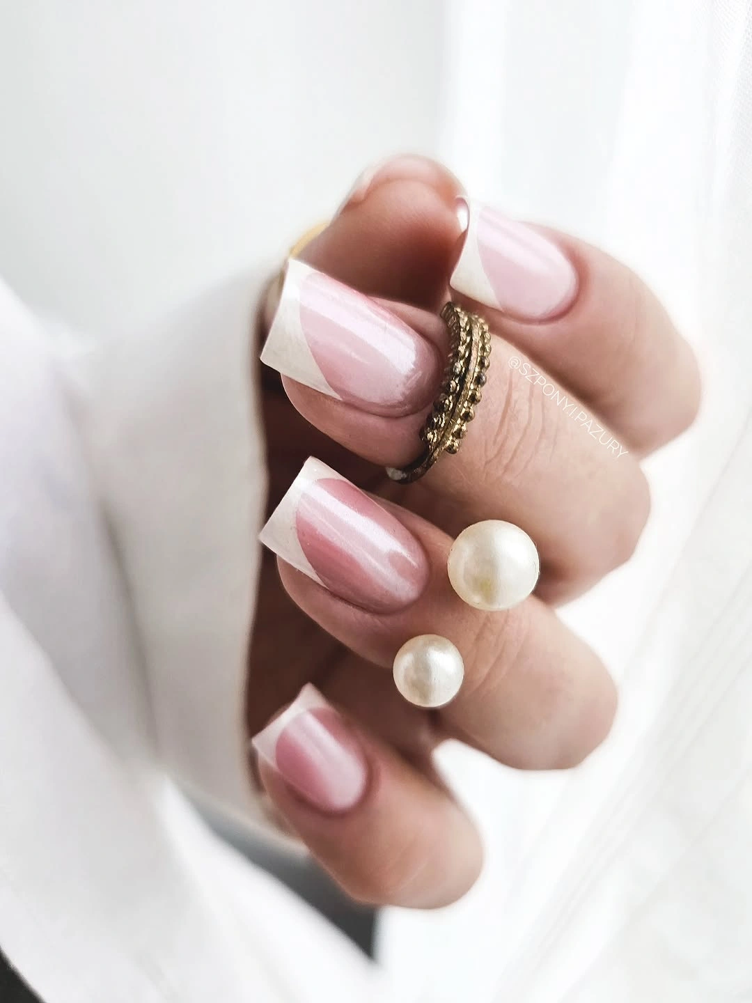 Compact square nails with pink base and angled white tips
