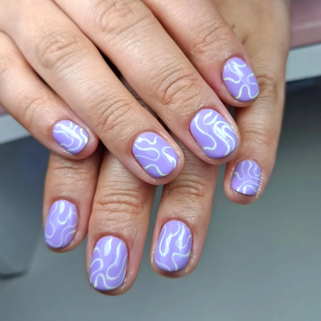 Lavender rounded short nails with white wavy line art