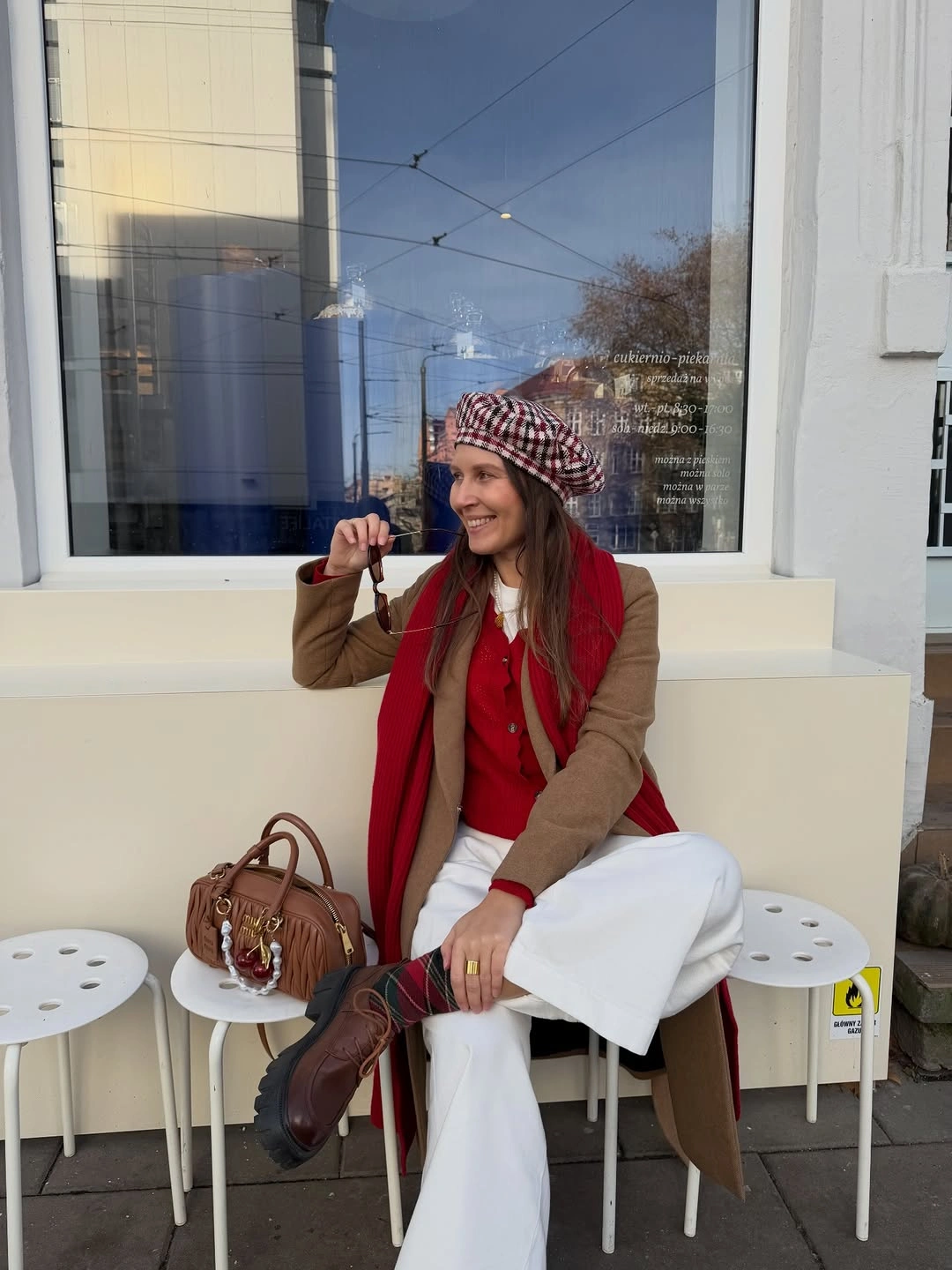 Camel jacket with striped red scarf and white trousers