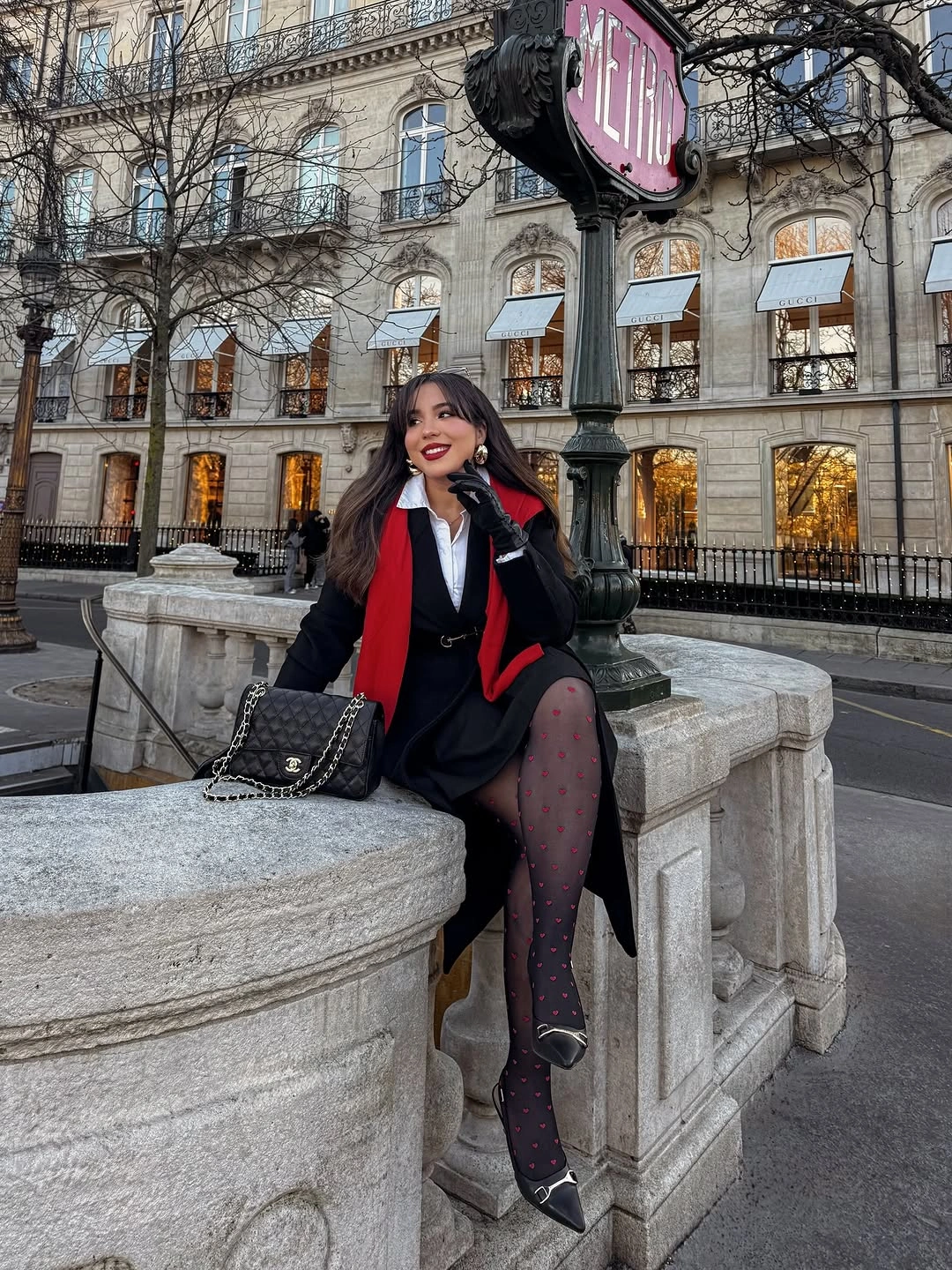 Black coat red scarf short skirt and knee high boots