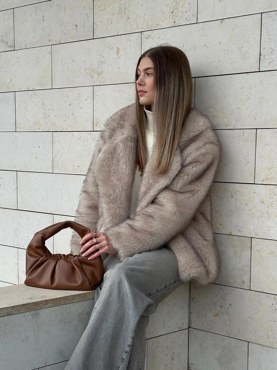 Pale fuzzy jacket with cream trousers brown structured bag