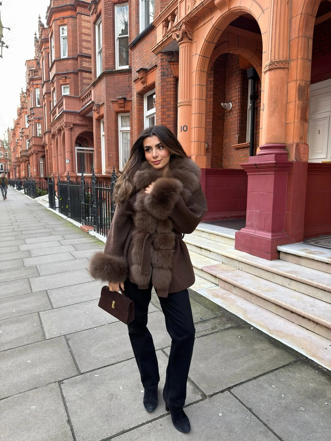 Brown textured jacket with dark jeans pointed boots and bag