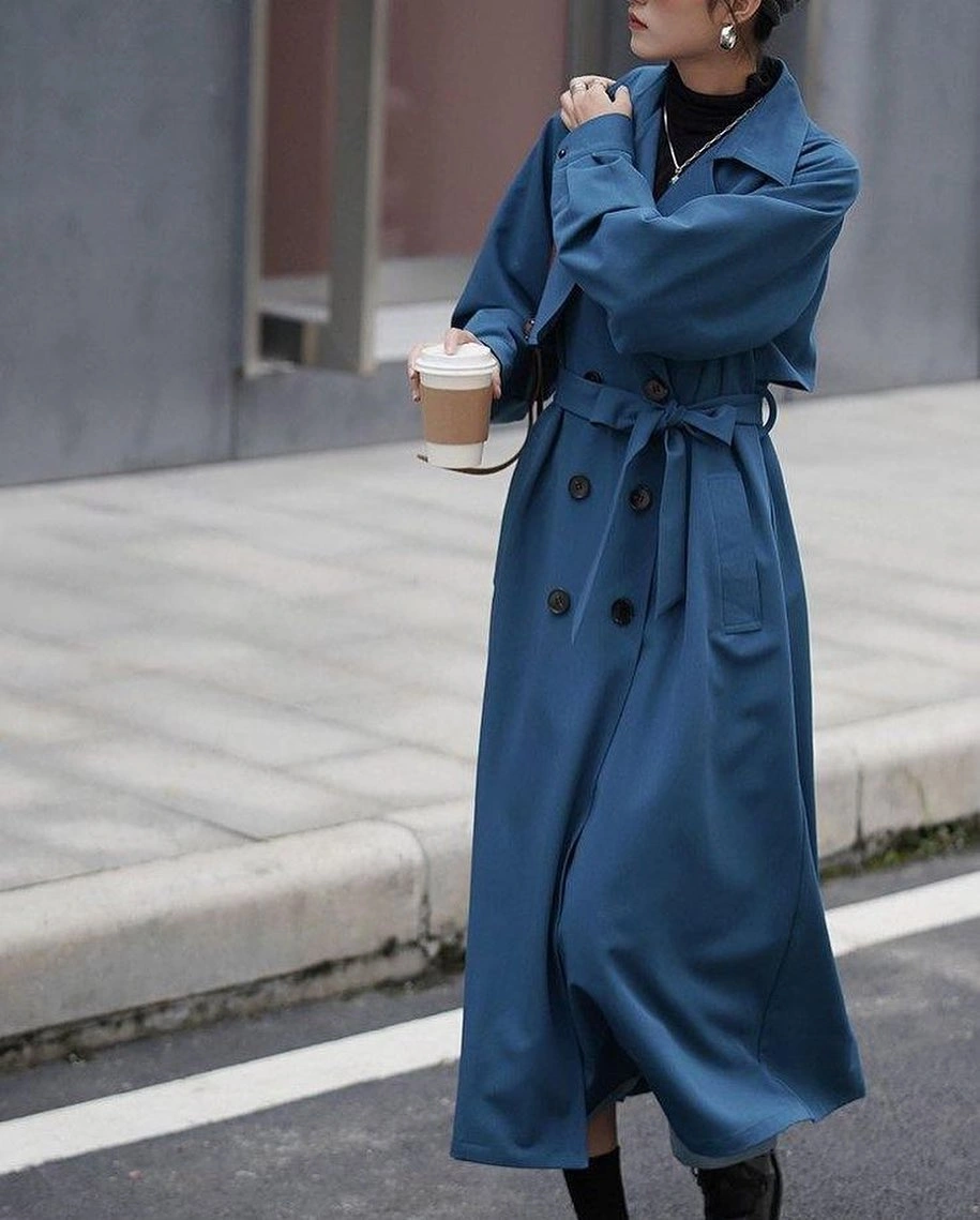 Blue long belted coat over black high-neck layer