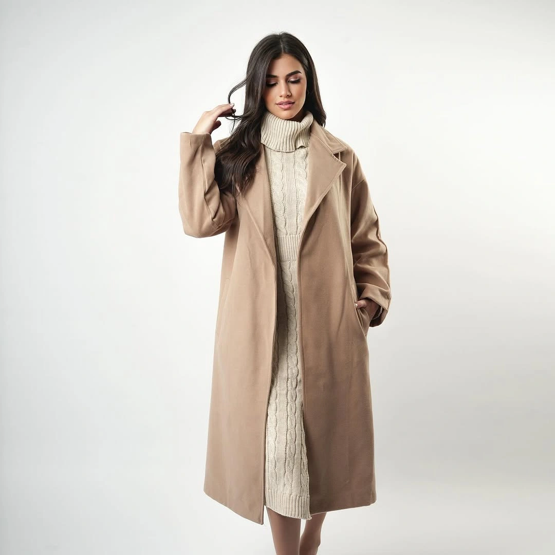 Camel-brown long coat over cream cable-textured turtleneck dress