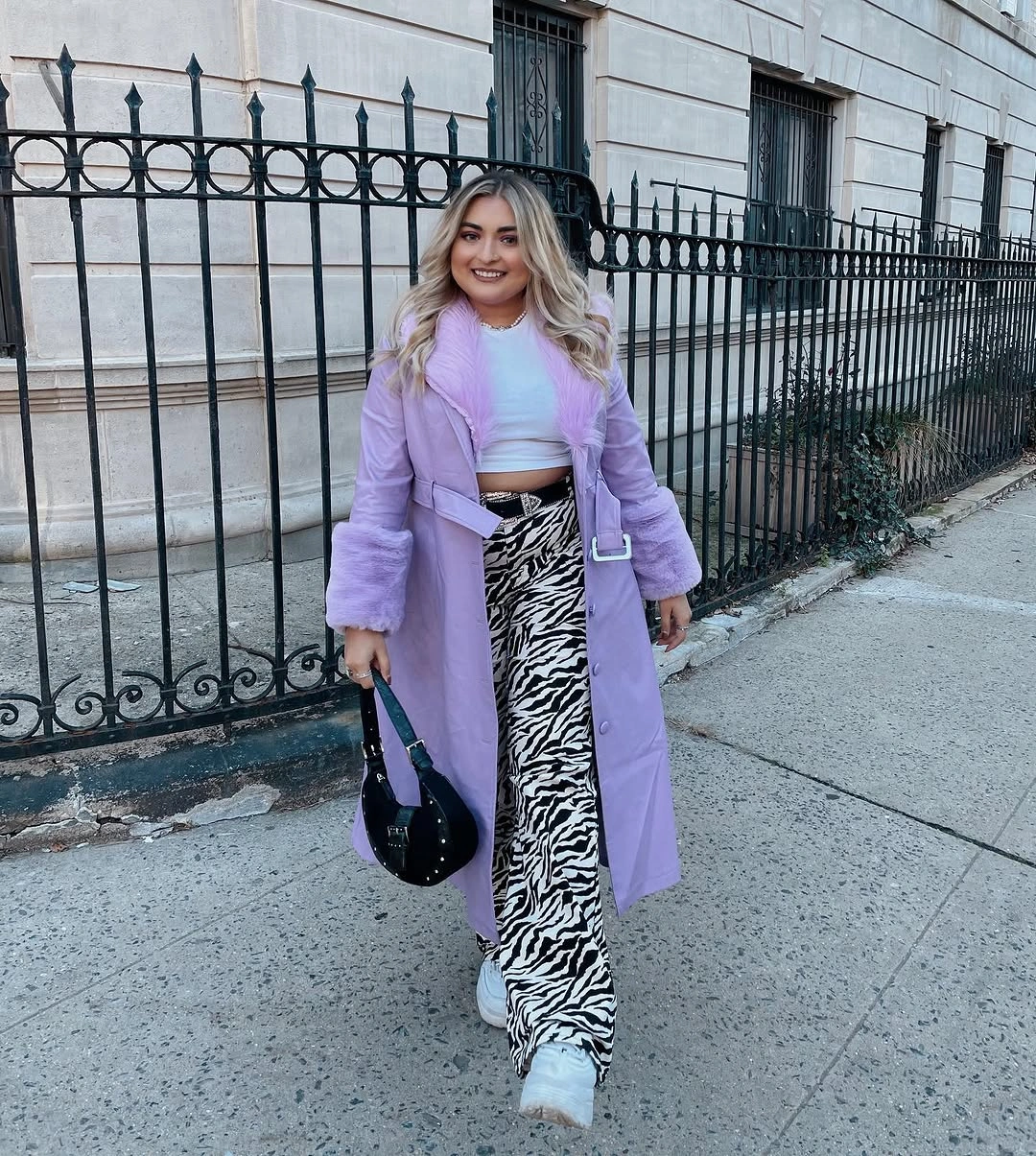 Lavender long coat with animal-print trousers and white sneakers