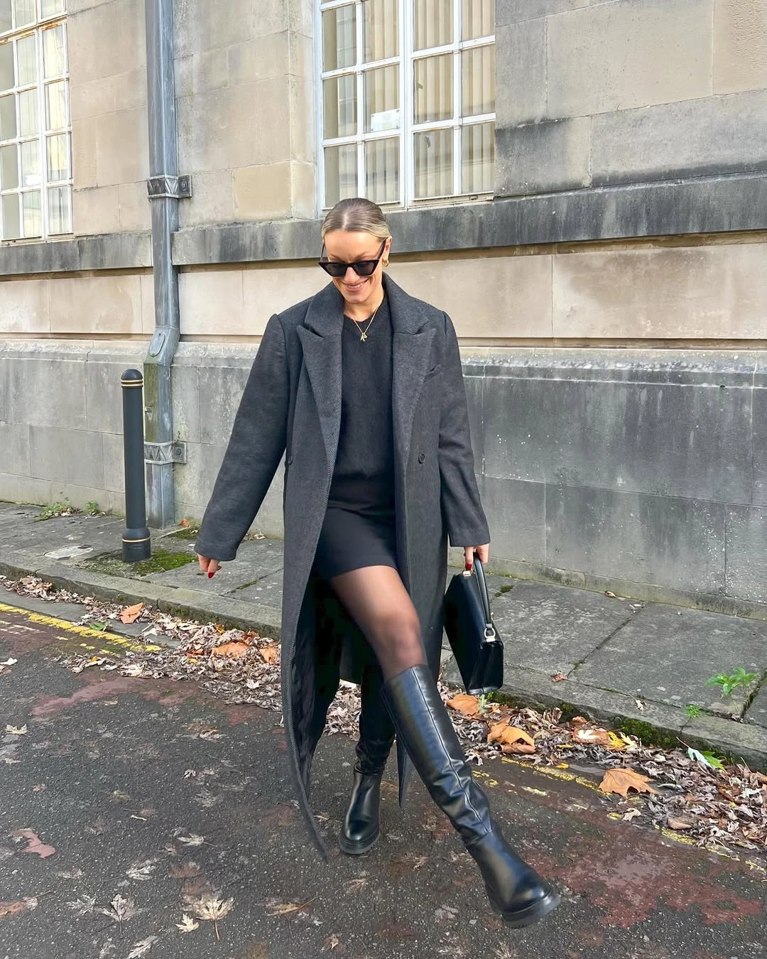 Charcoal long coat over black outfit and tall boots