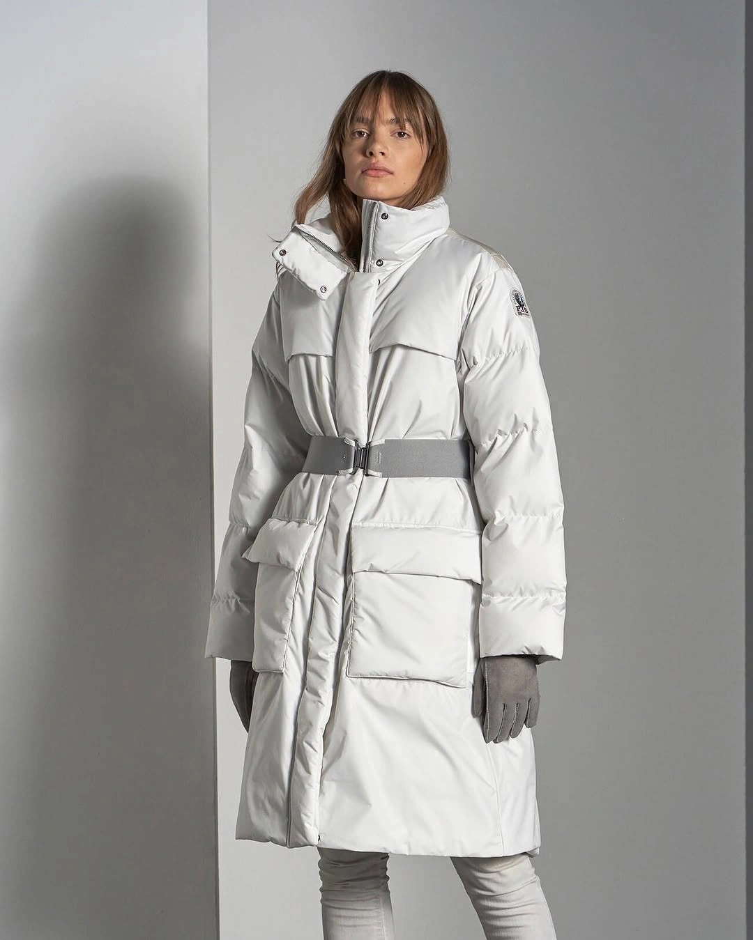 Long white padded coat with gray belt and gloves