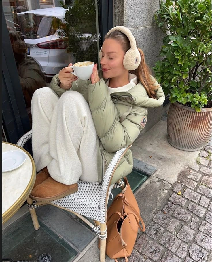 Pale green padded vest with white layers and earmuffs