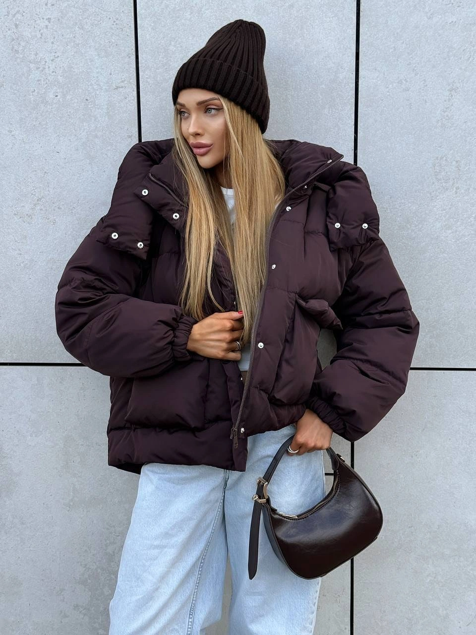Dark plum-brown cropped padded jacket with beanie and jeans