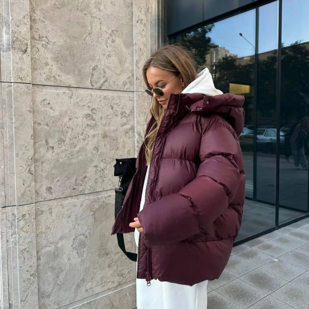 Burgundy cropped padded jacket over white hoodie and trousers