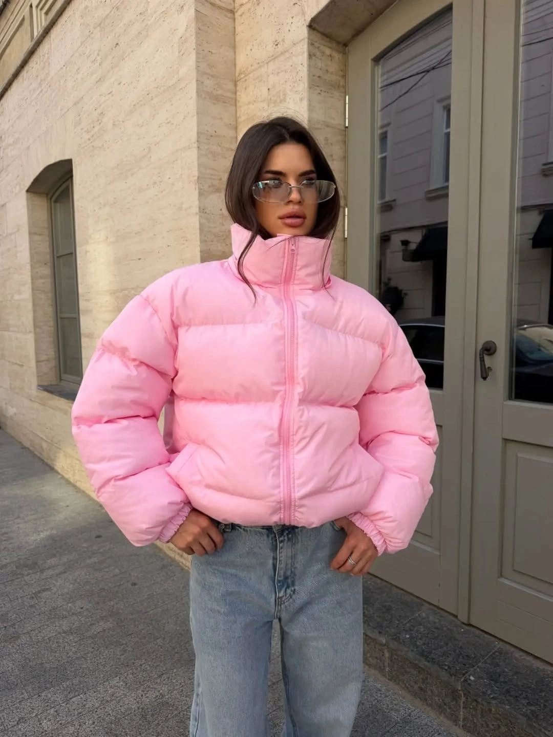 Oversized pale pink cropped padded jacket with light jeans