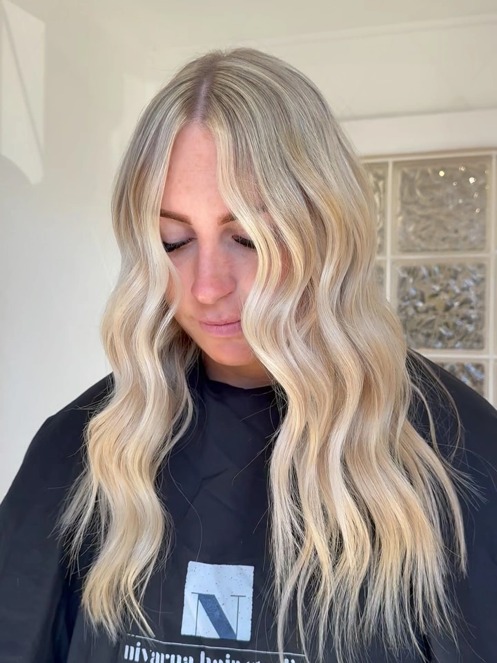 Medium long pale blonde wavy layers with center part