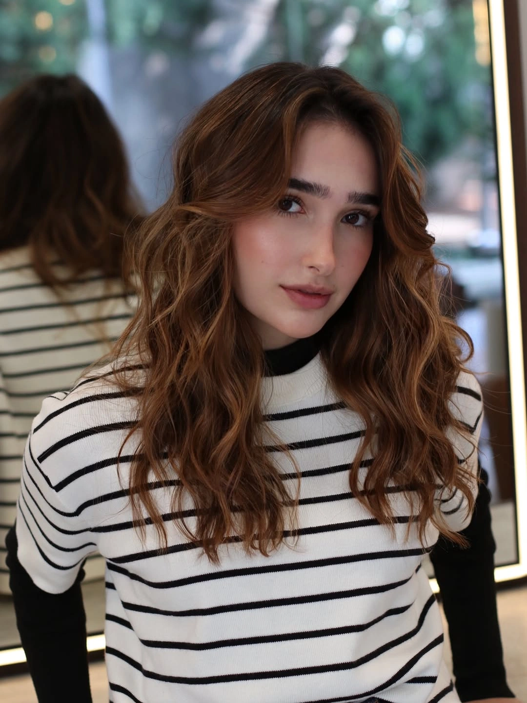 Medium auburn brown curly waves with curtain bangs