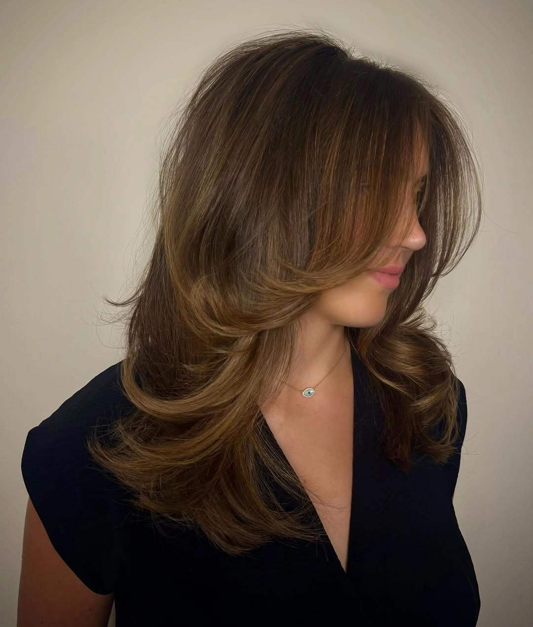 Medium caramel brown hair with feathered curtain front