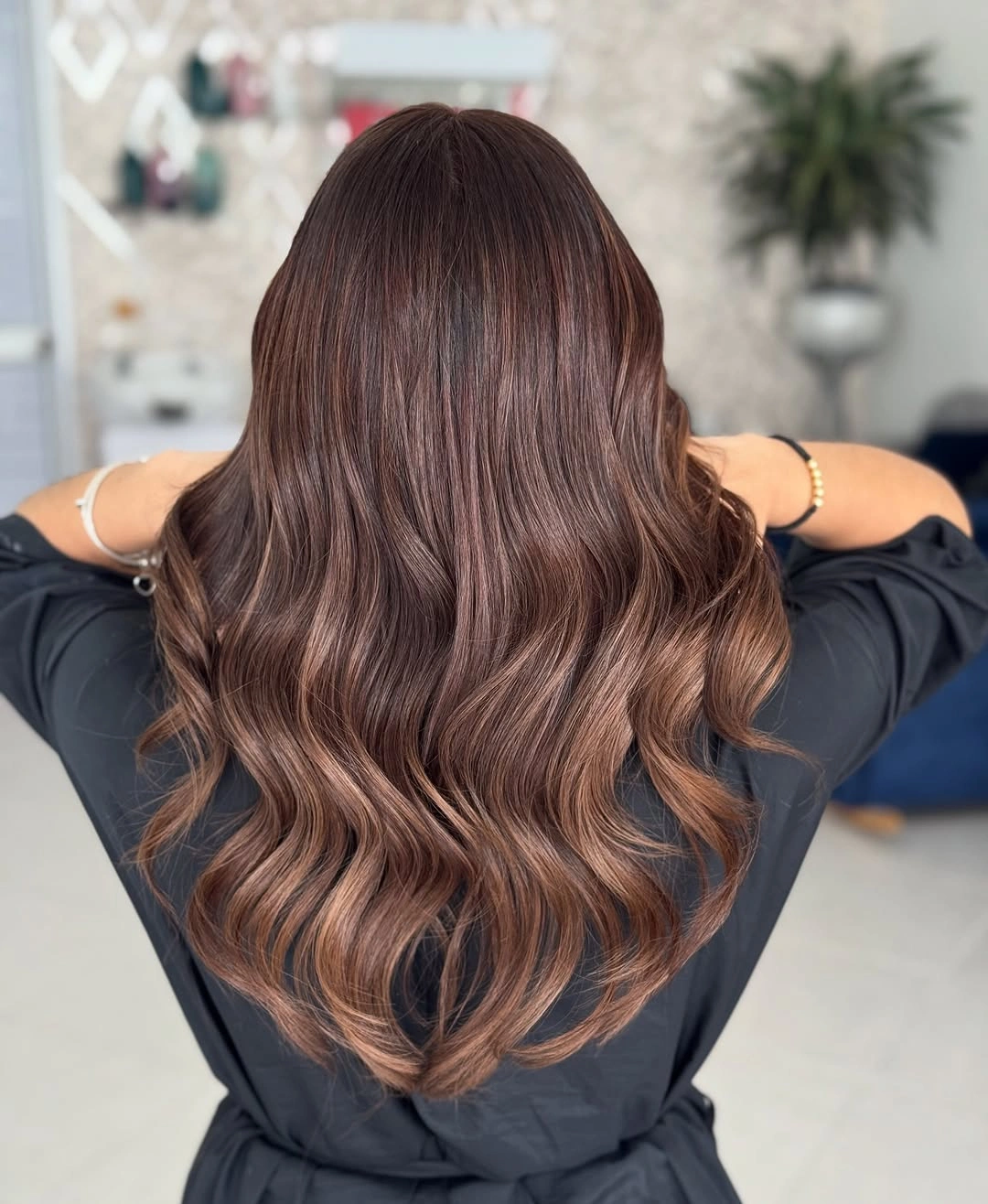 Medium long reddish brunette wavy hair from back