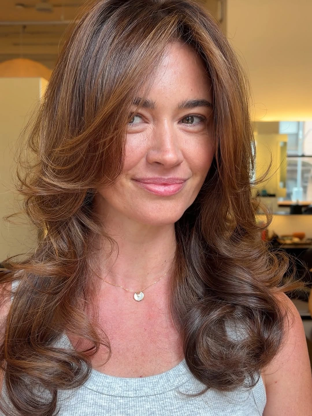 Medium auburn brown layered hair with flippy ends