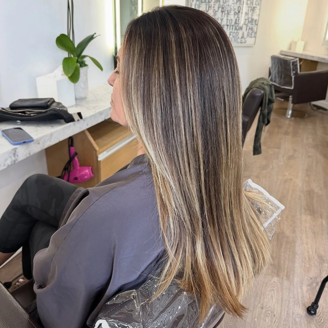 Long light brown hair with beige highlighted layers