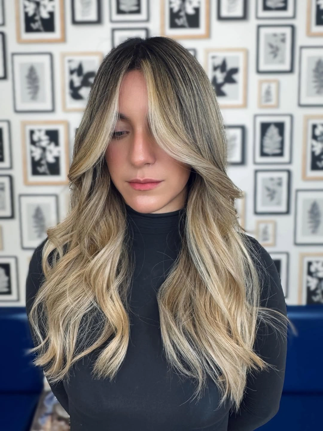 Long blonde balayage hair with curtain bangs