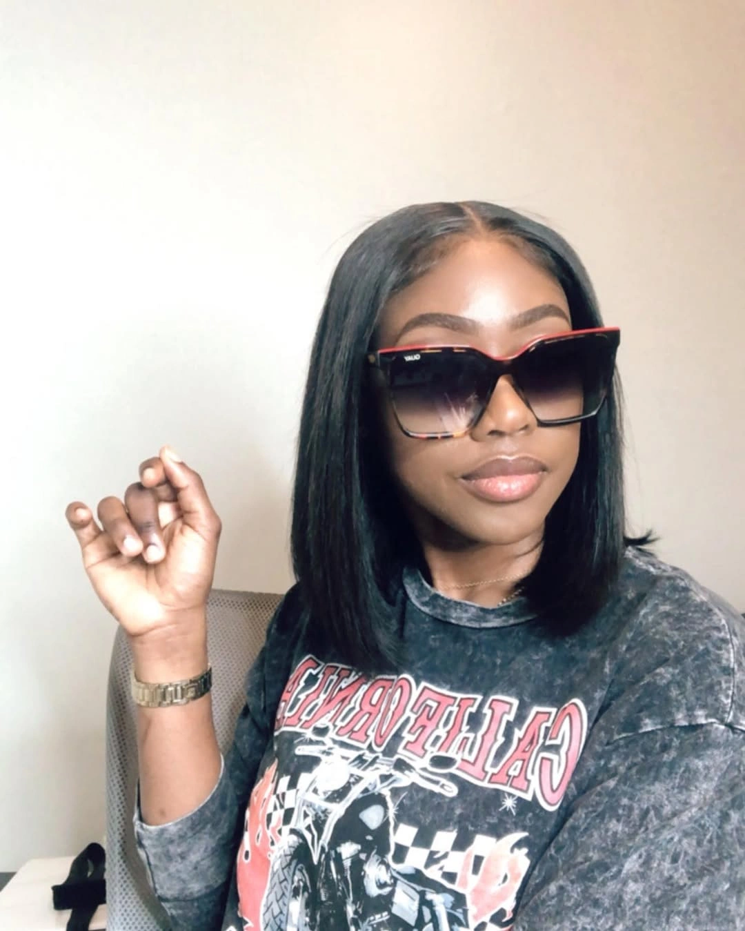 Smooth center-parted dark bob with shoulder-length edge