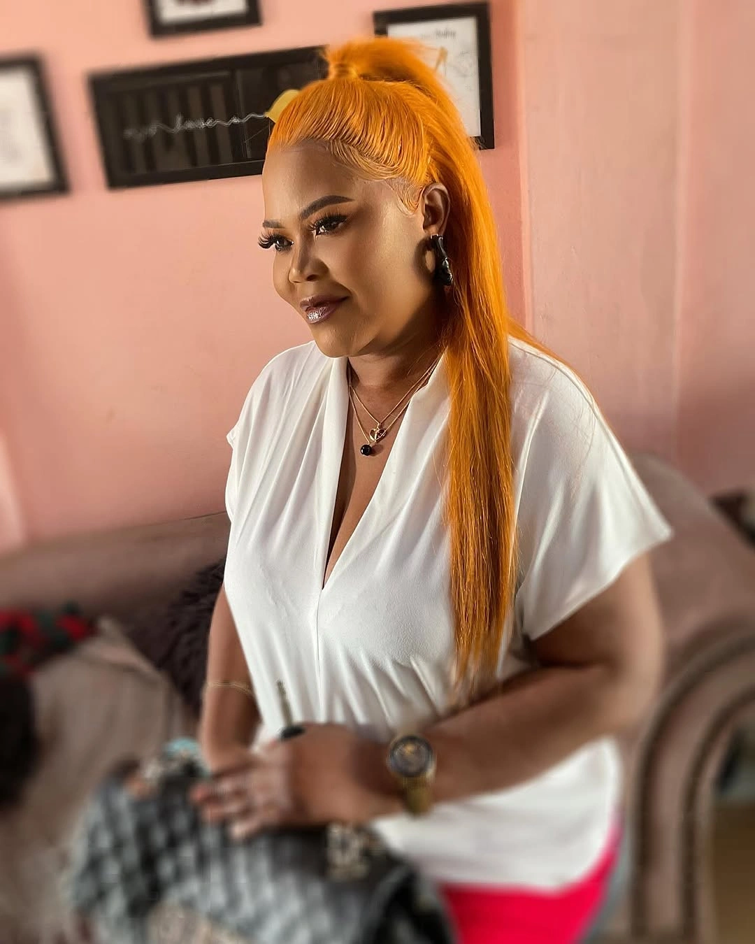 Vivid orange high ponytail with smooth crown and edges