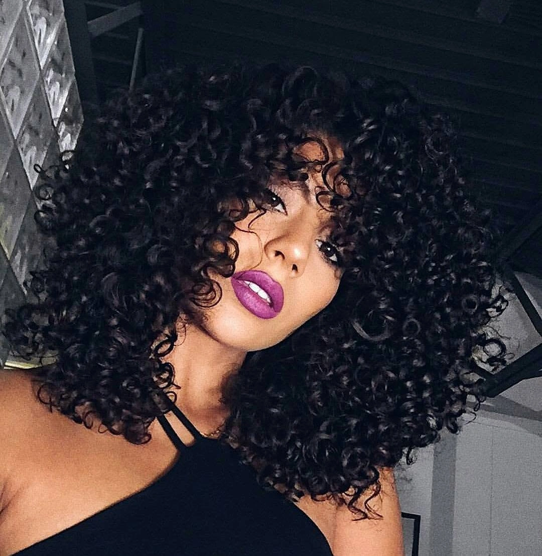 Rounded black curls with curly fringe across forehead
