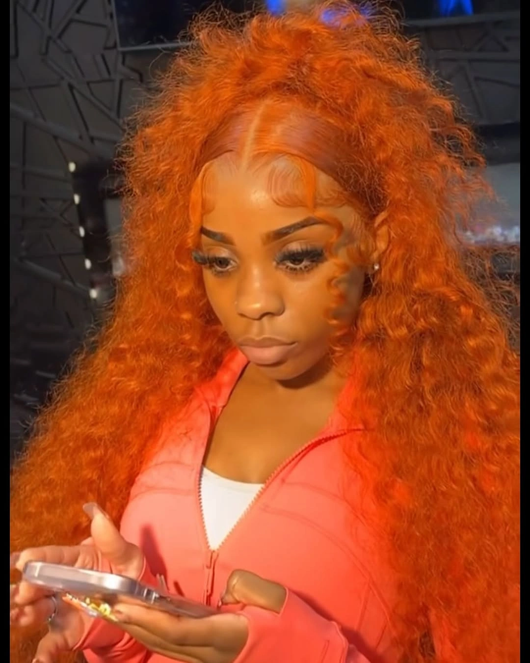 Bright orange long curls with sculpted front edge detail