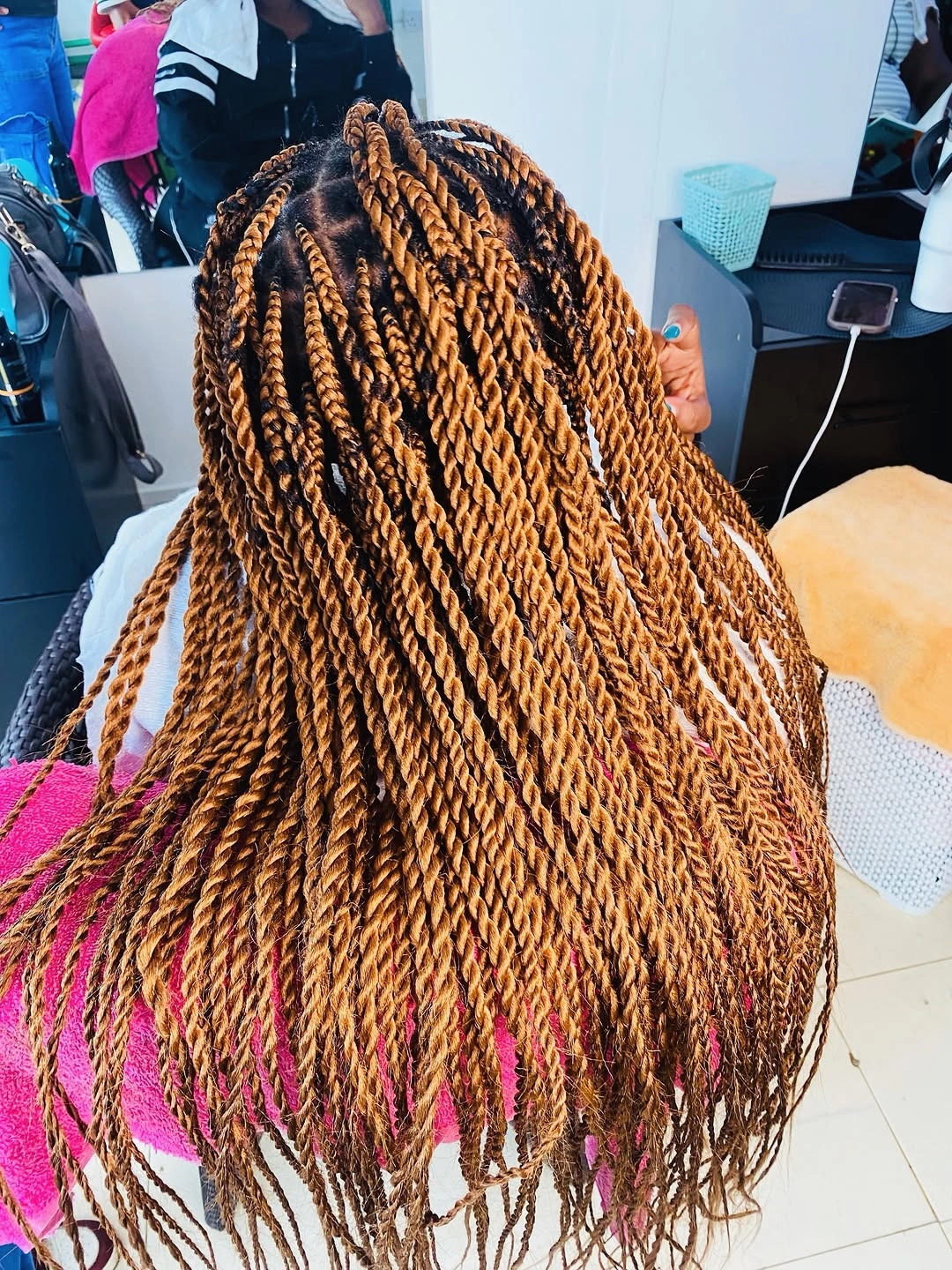 Long warm-brown twisted sections with visible scalp parting