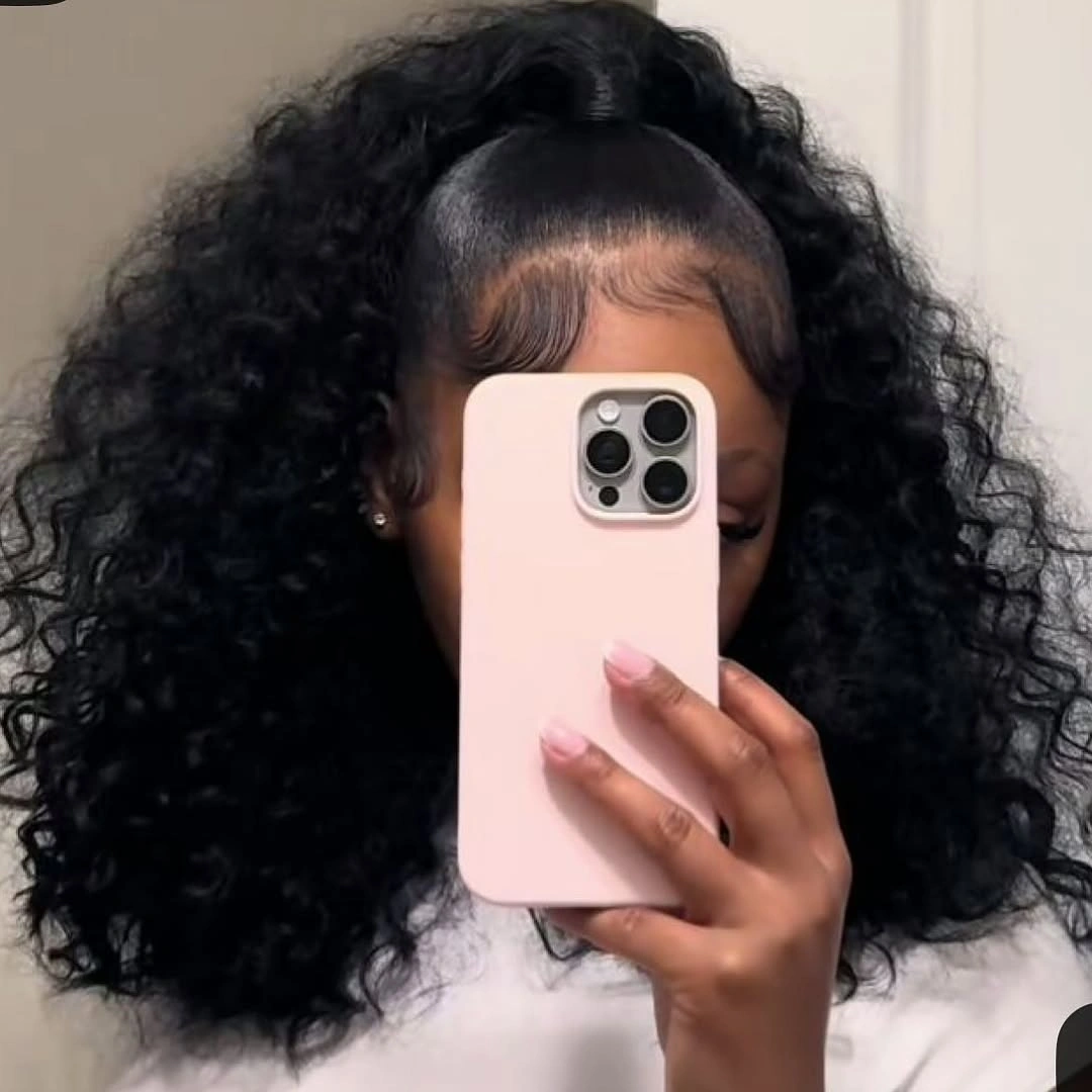 Voluminous black curls with sleek front and gathered crown