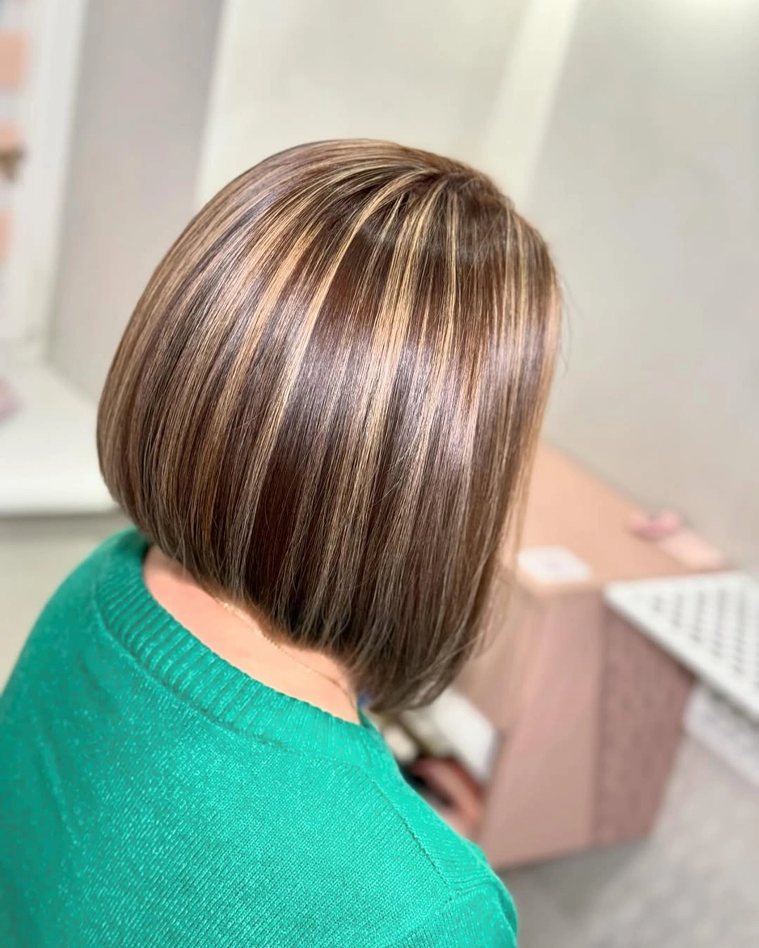 Short brown highlighted bob with layered-looking back volume