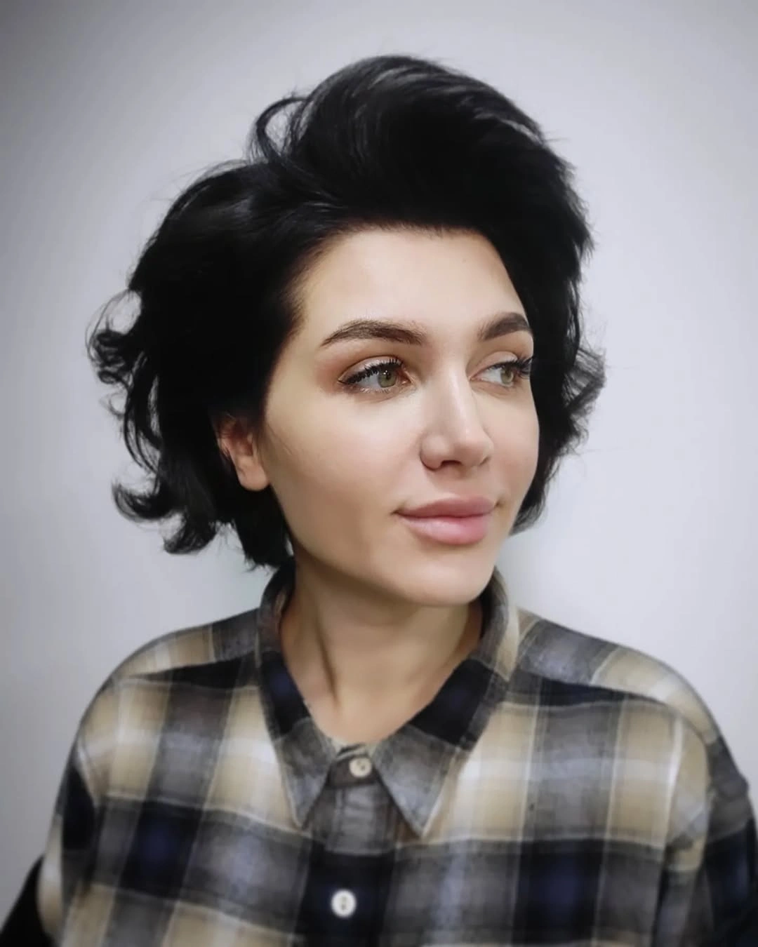 Short black curly bob with rounded face-framing shape
