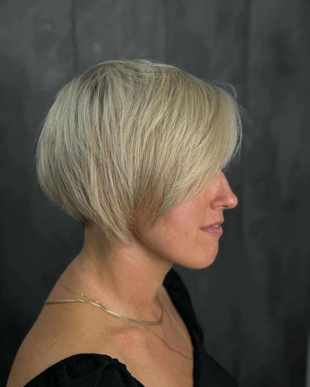 Platinum short rounded bob shown in side profile