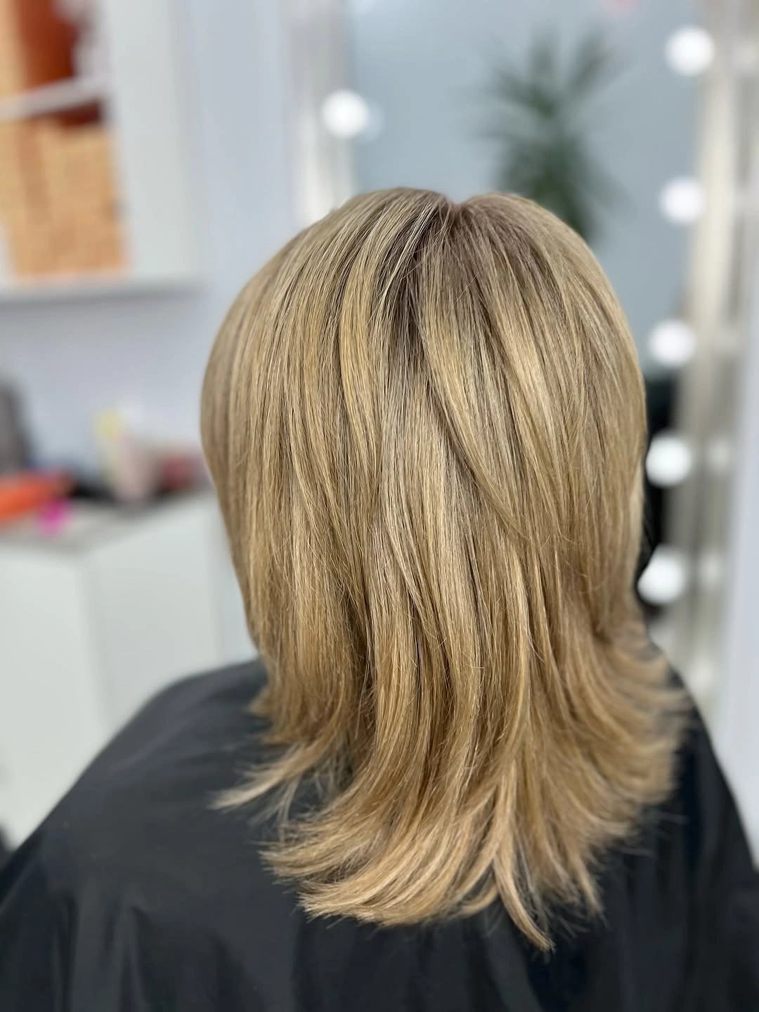 Medium blonde layered haircut with flipped ends