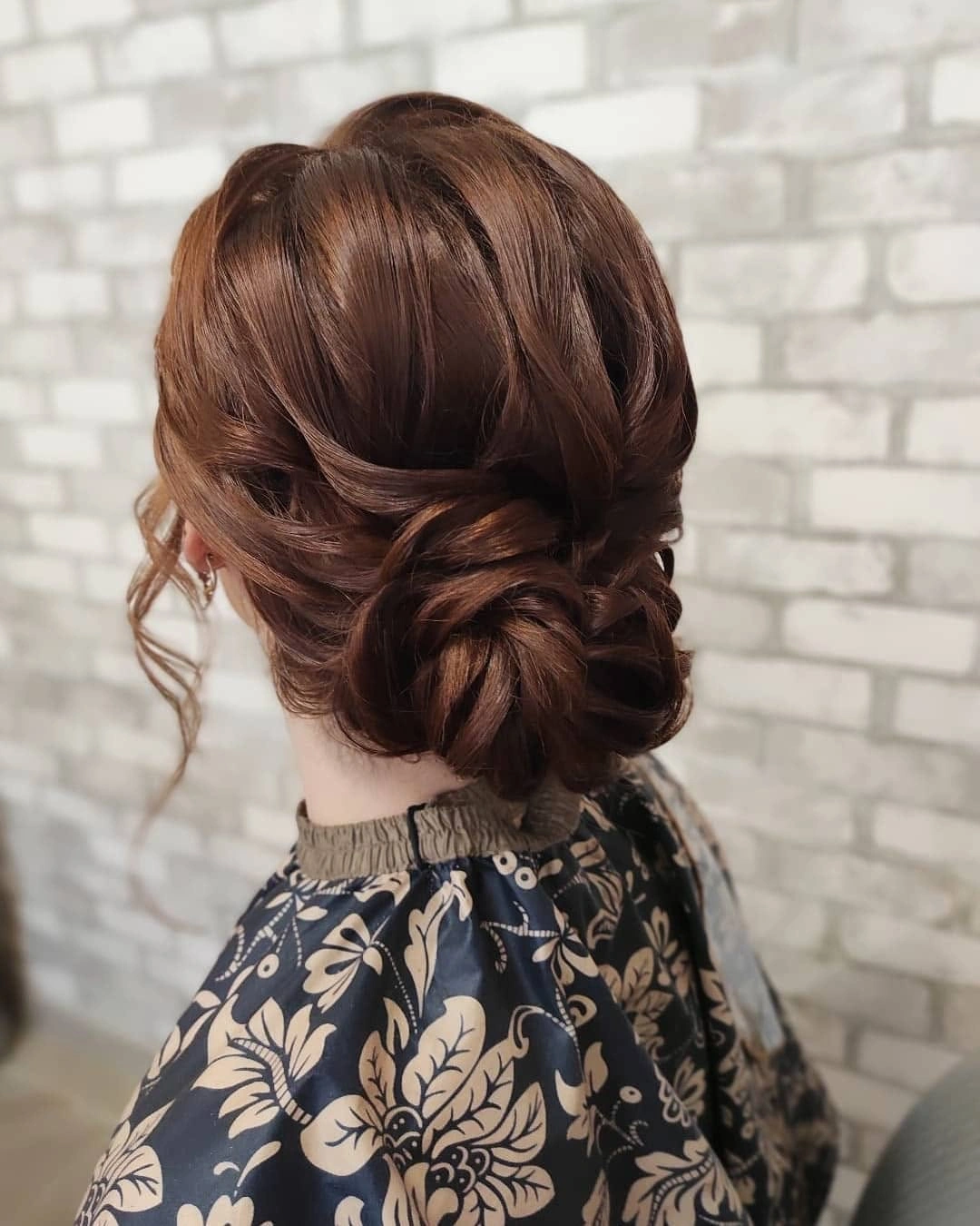 Warm brown braided low bun viewed from behind
