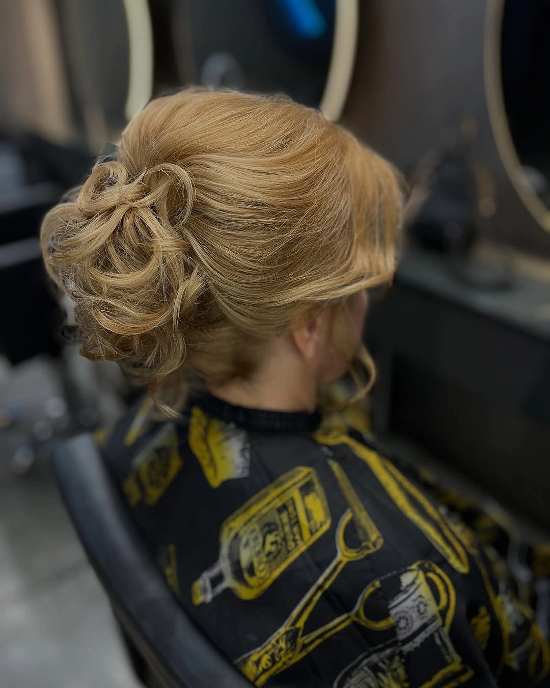Blonde updo with curled pinned bun structure