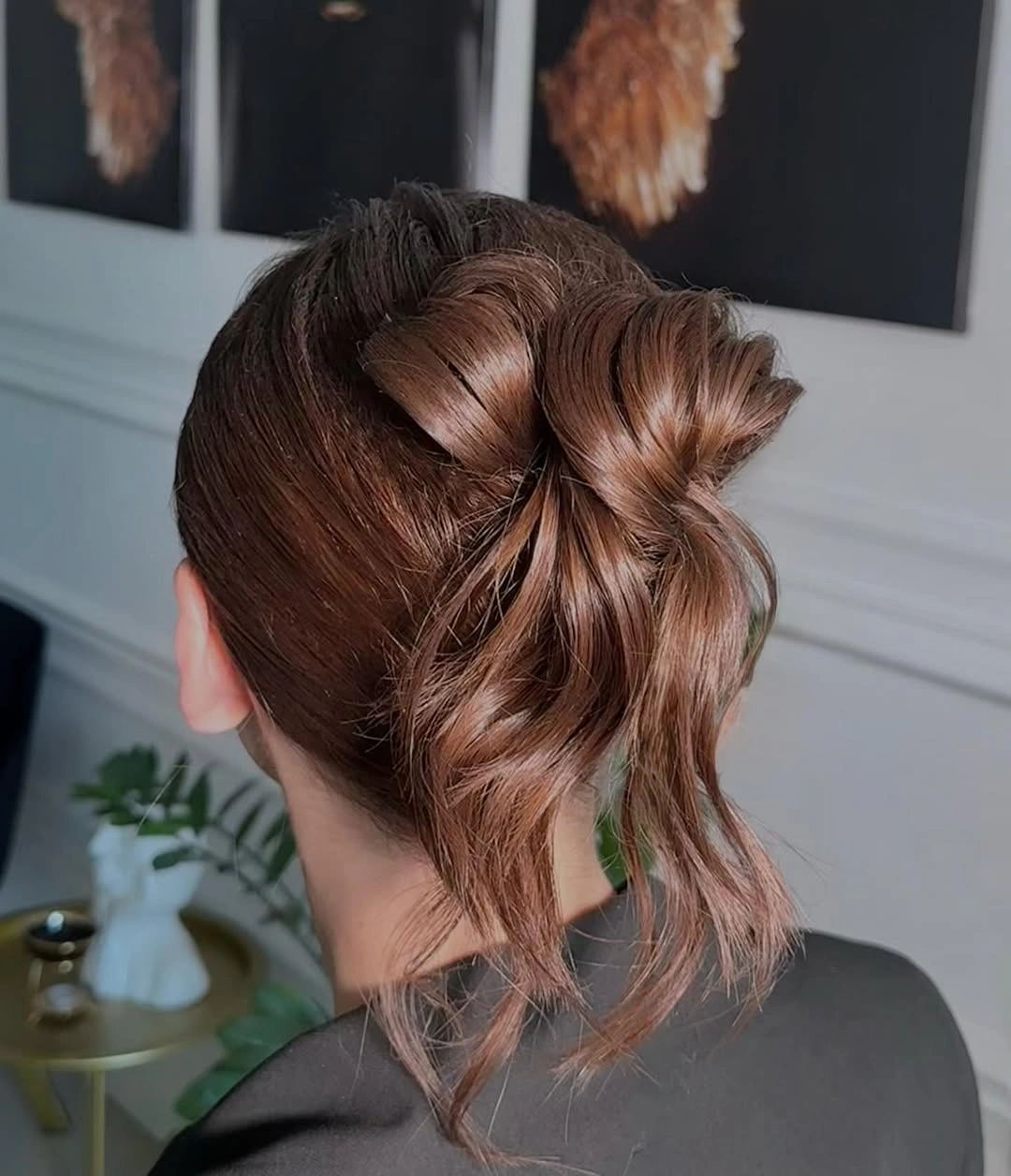 Auburn curled ponytail updo with loose back ends