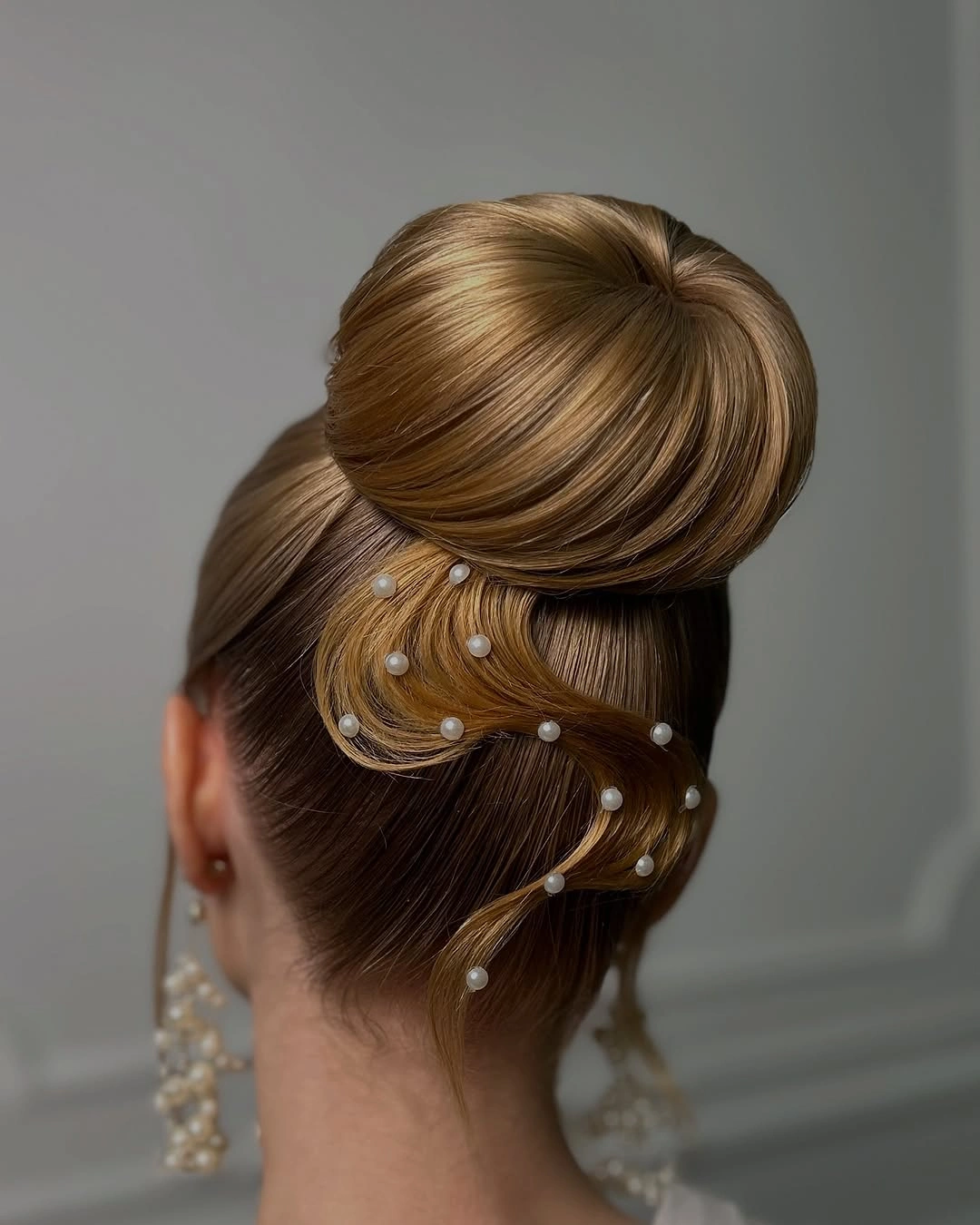 Brown updo with pearl-like pins from the back
