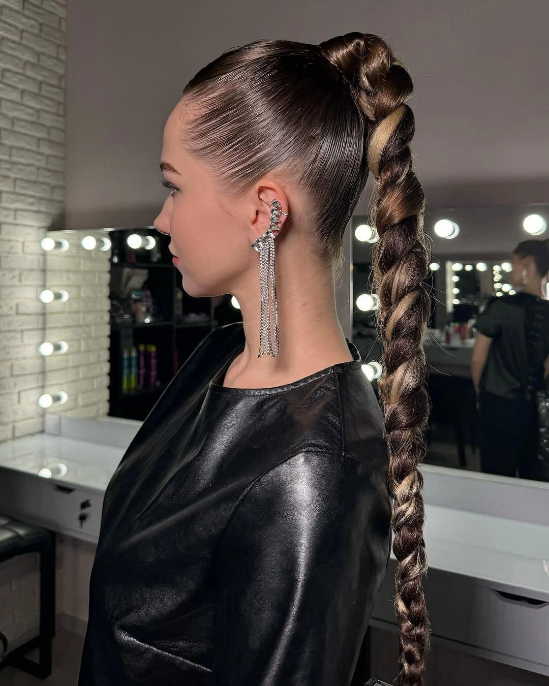 Long dark braided ponytail with smooth pulled back top