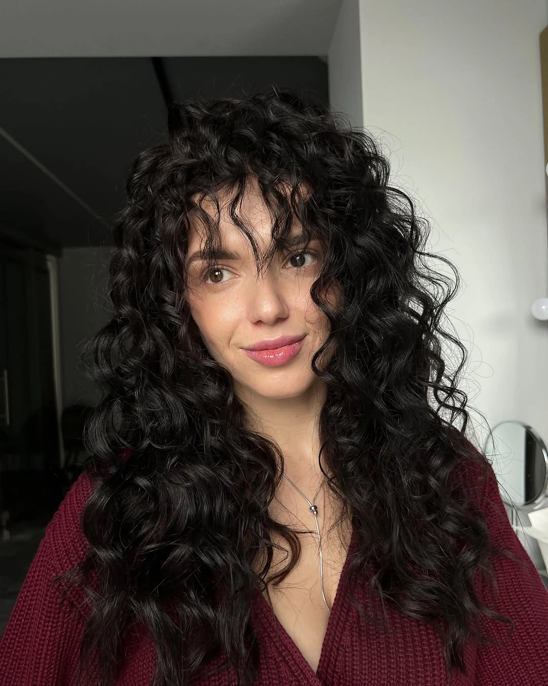 Long dark curly hair with rounded front framing