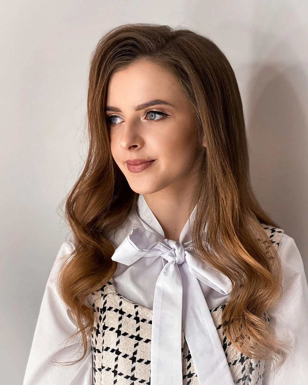 Long brown wavy hair with white blouse bow