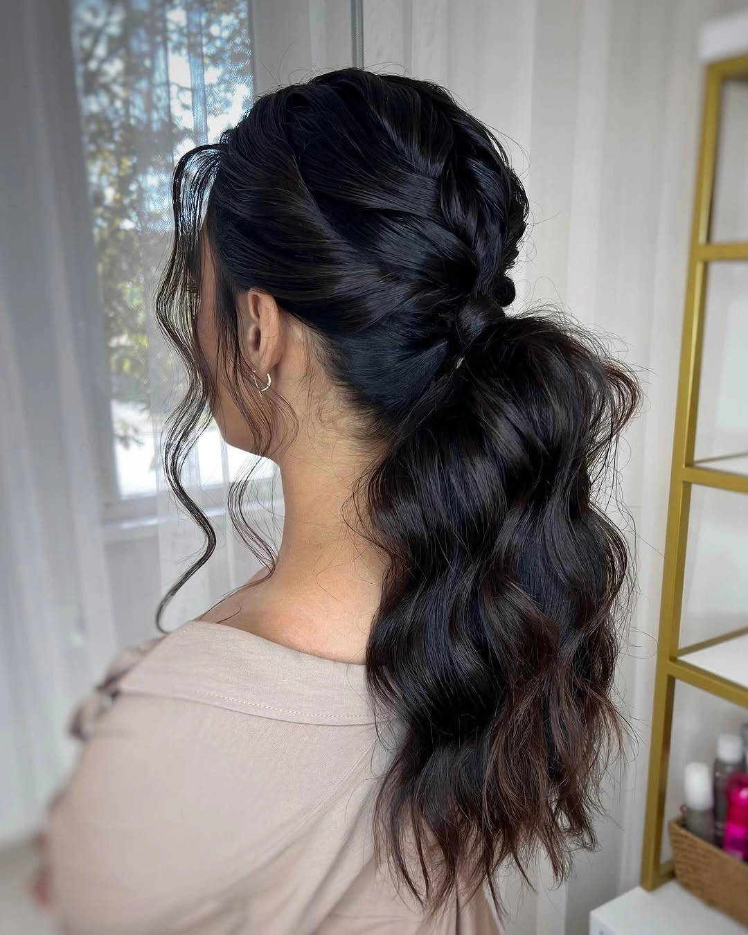 Black braided section leading into wavy ponytail