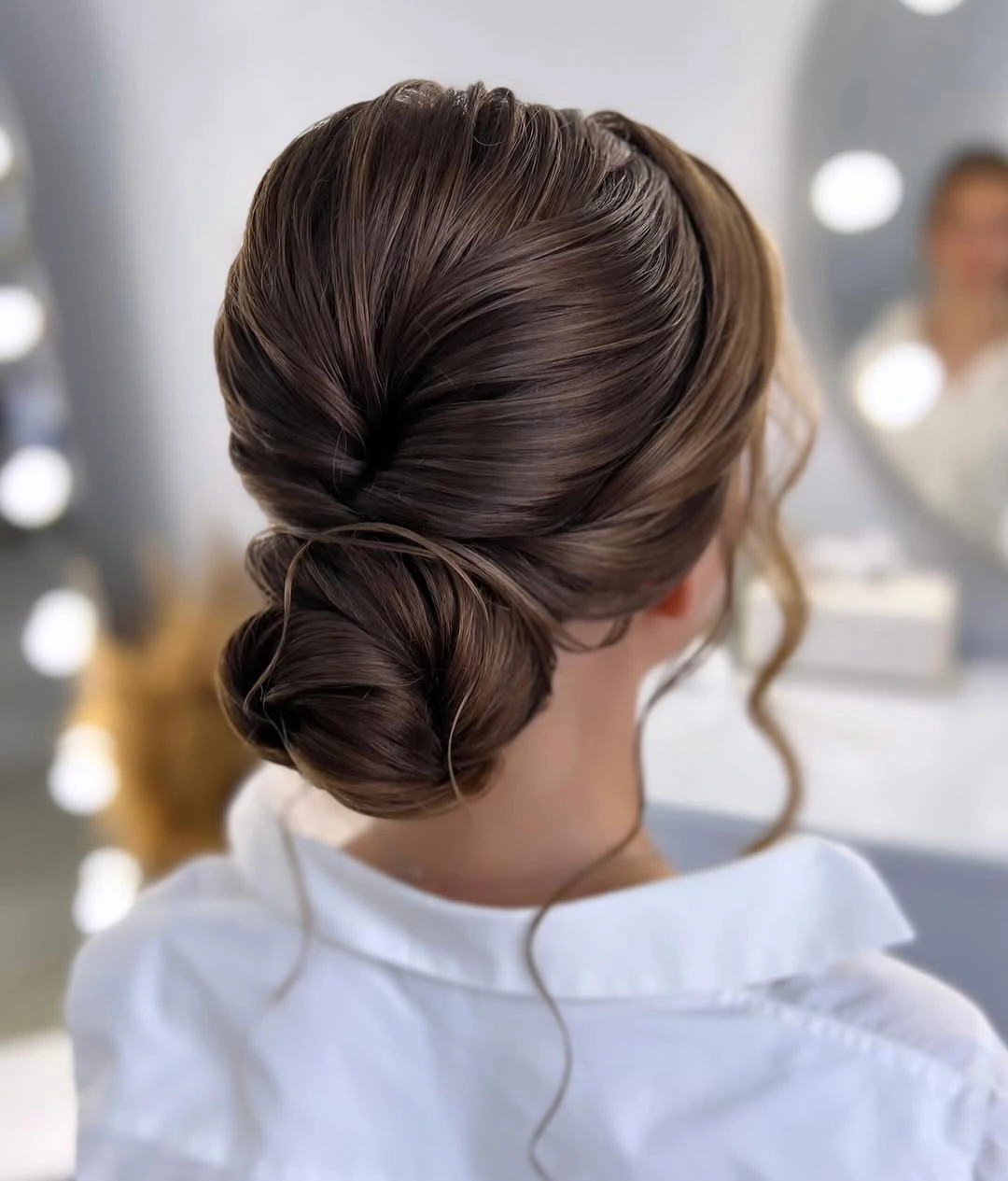 Sleek low brown bun with smooth pulled back hair
