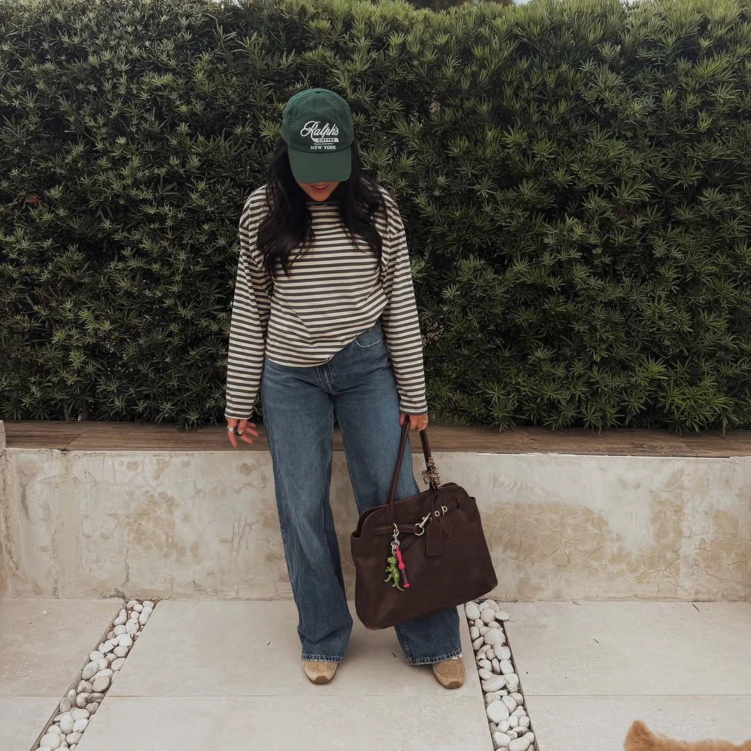 Striped top with wide jeans and green cap