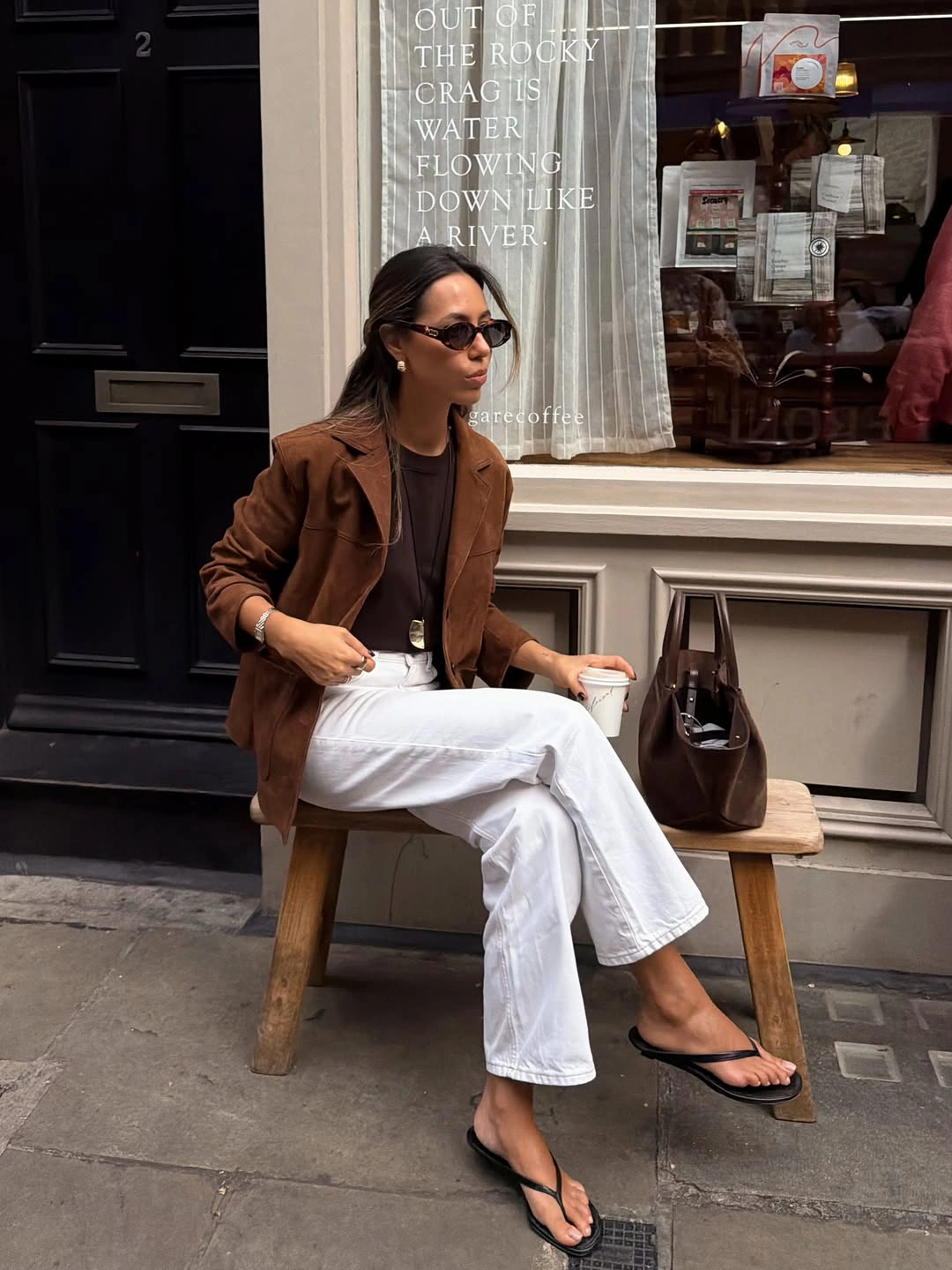 Brown jacket with white jeans and black sandals