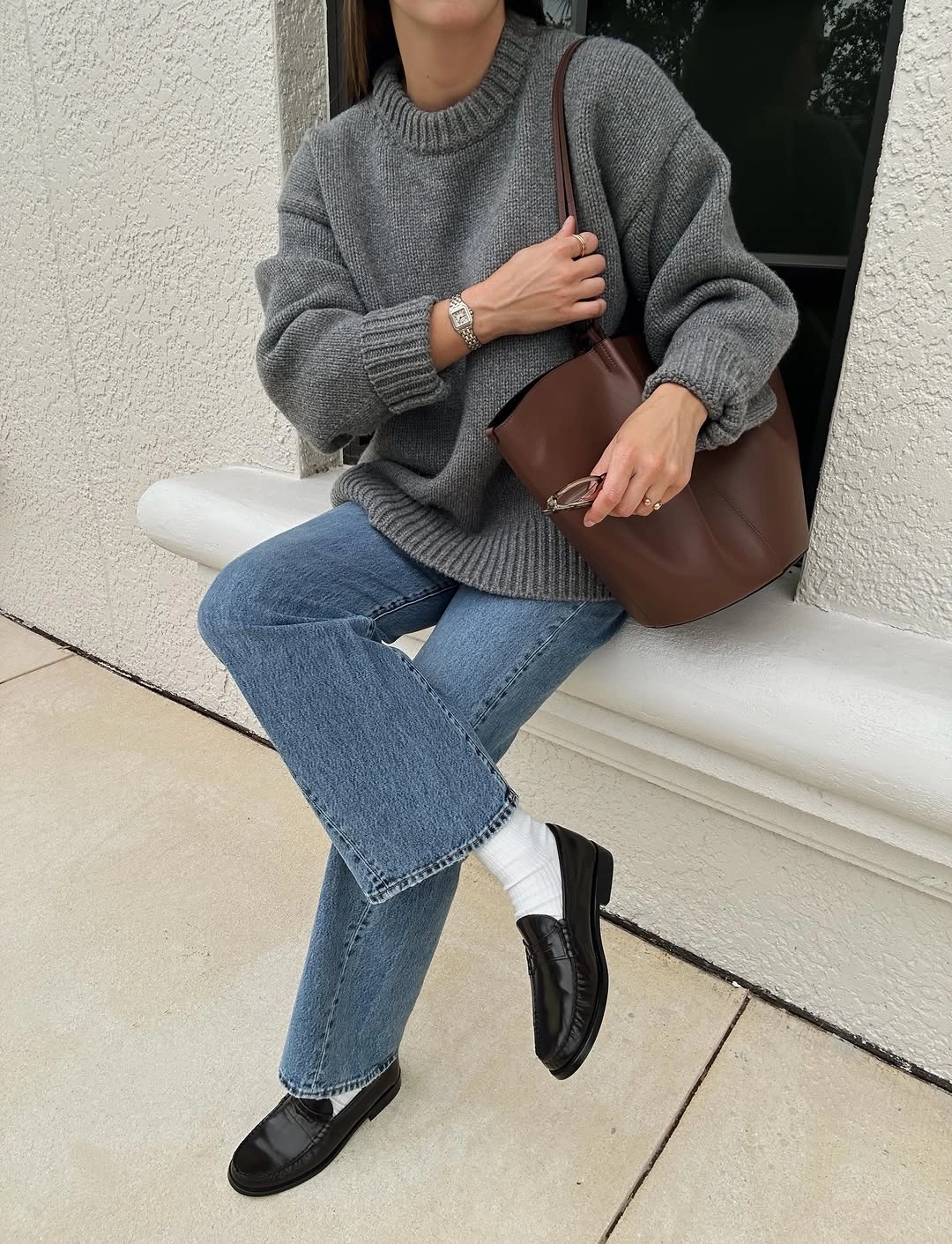 Chunky gray sweater with jeans and black loafers