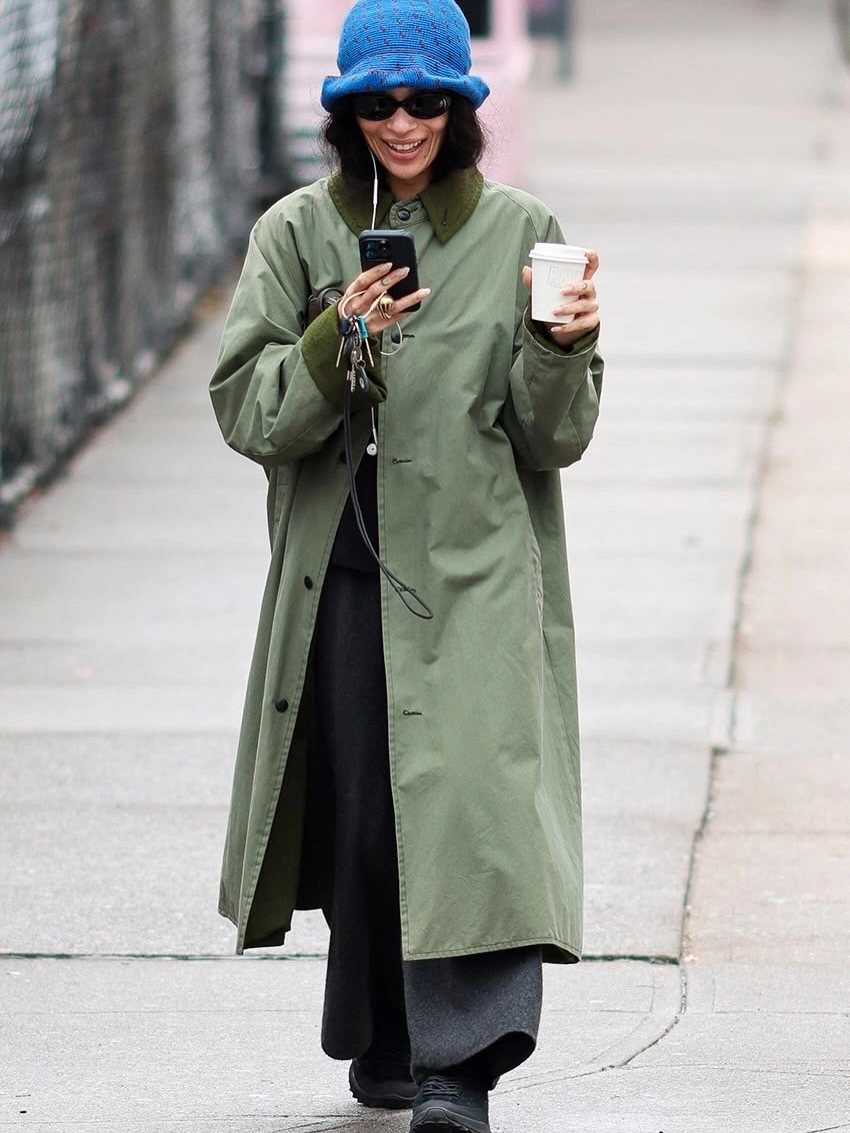 Sage green coat with blue fuzzy-looking bucket hat