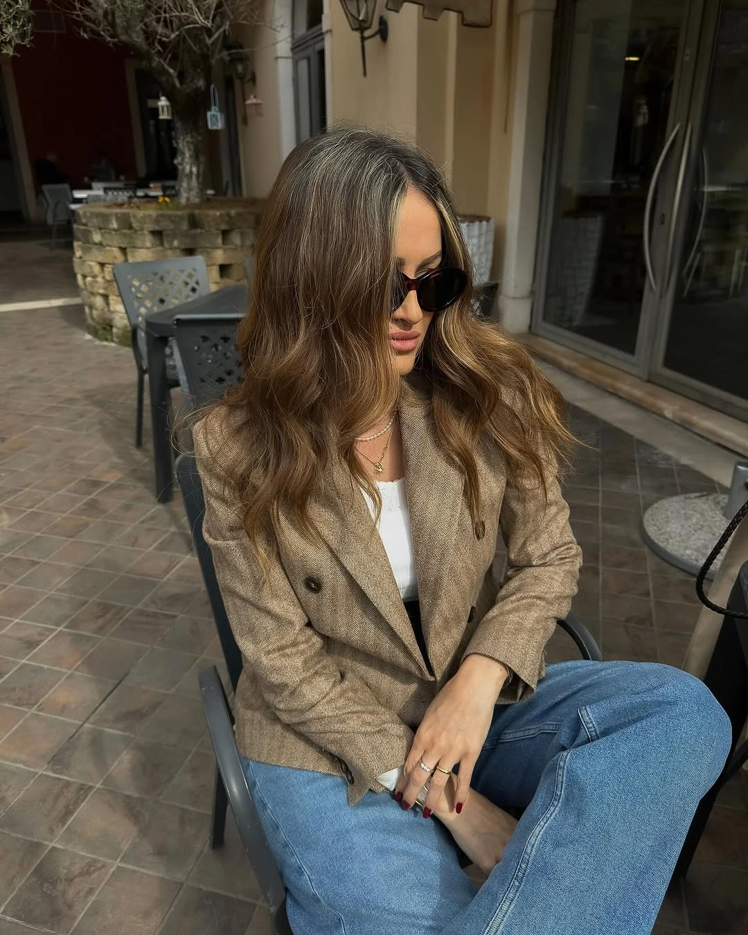 Tan double-breasted blazer with white top and jeans