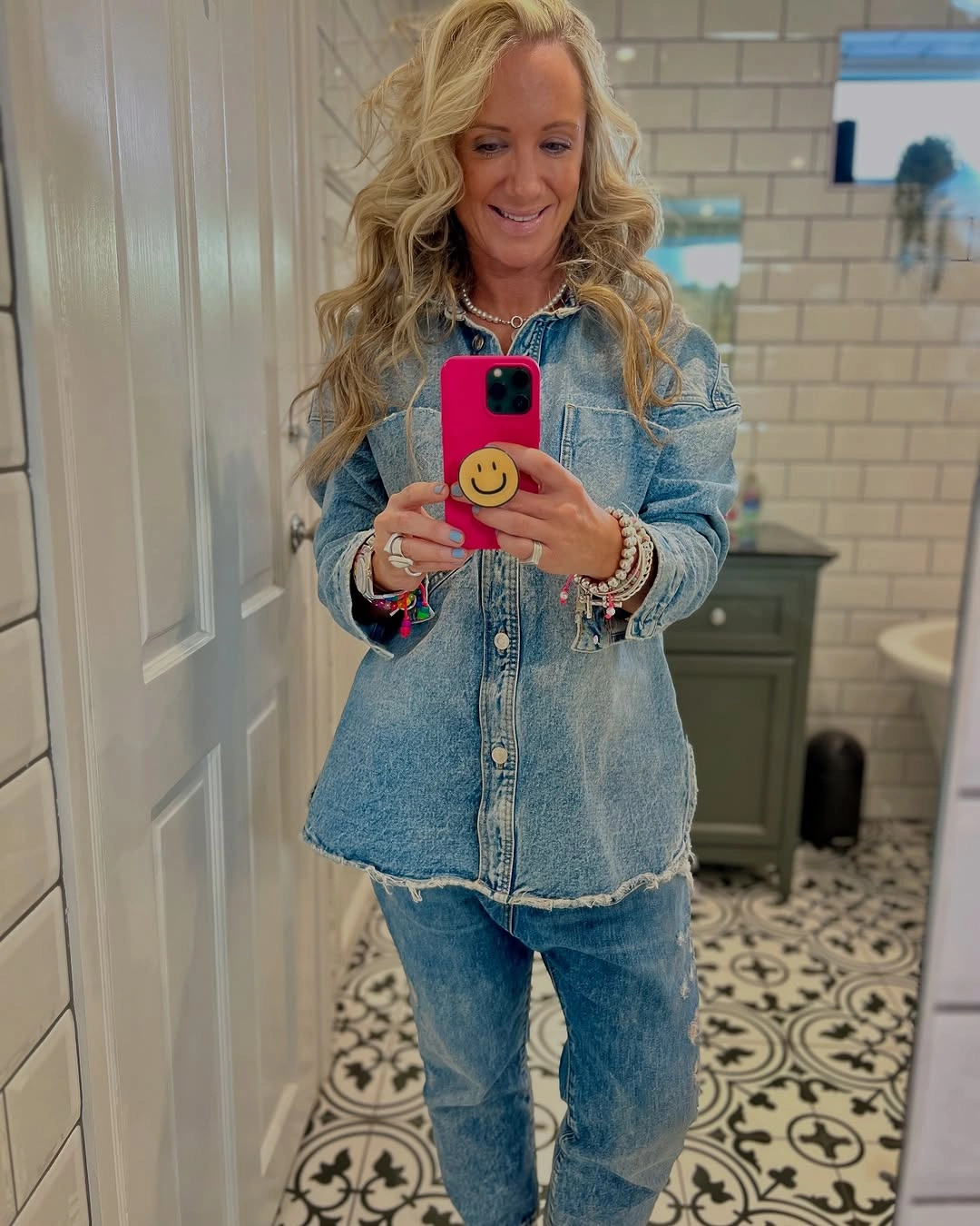Light denim shirt with blue jeans and bracelets