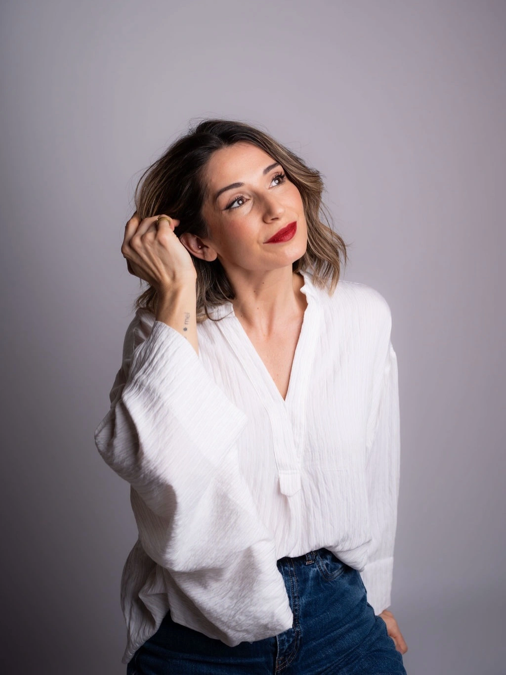 White textured blouse with deep blue jeans