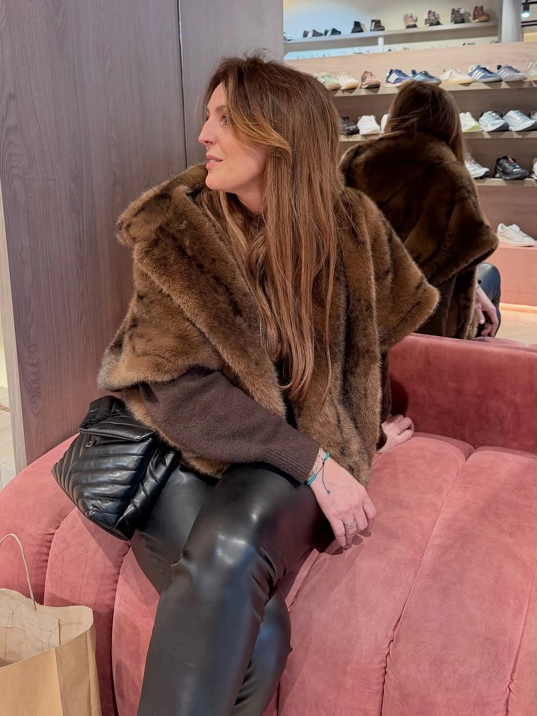 Brown fur-like wrap with black leather-look pants