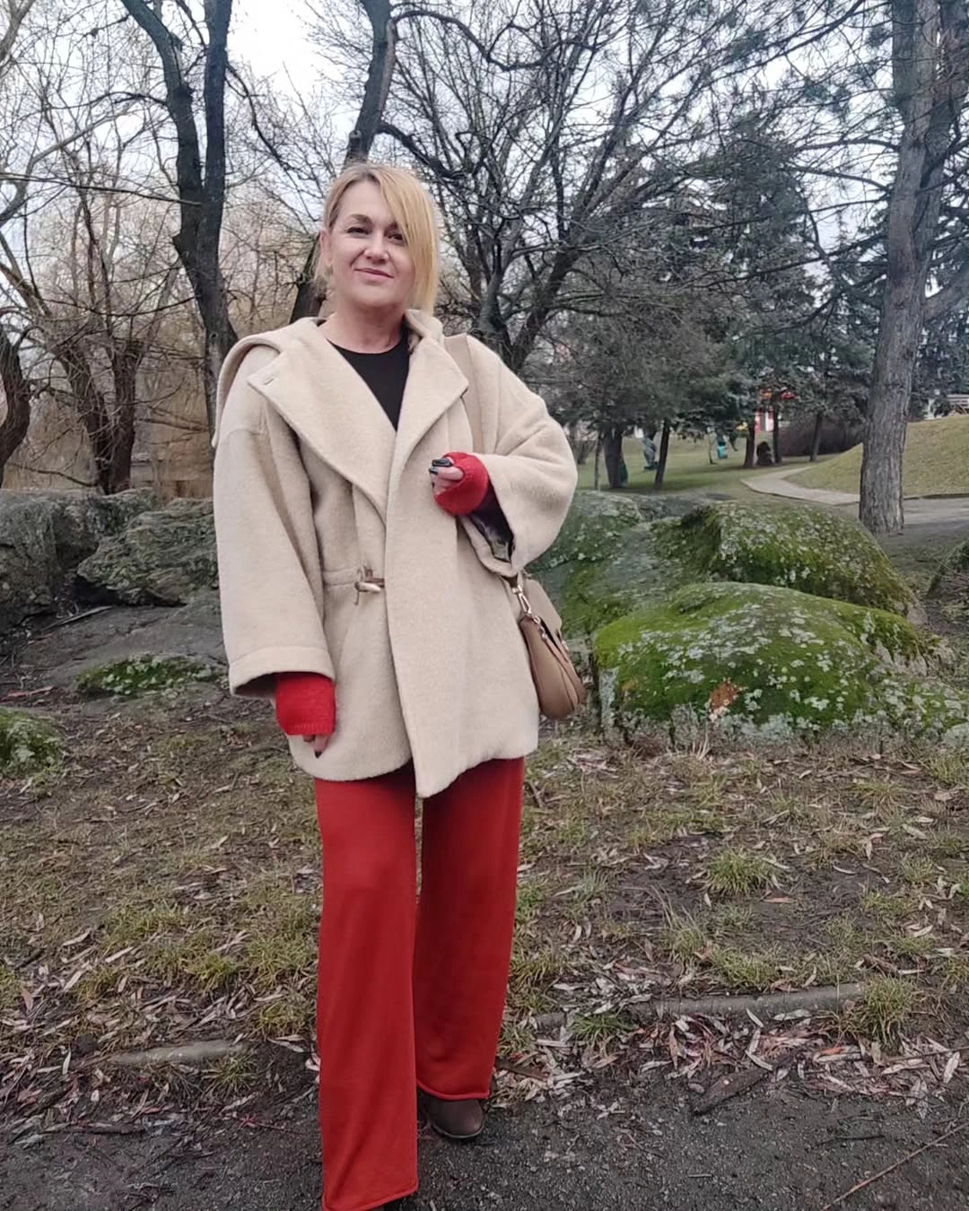 Pale short coat with red wide-leg pants and gloves